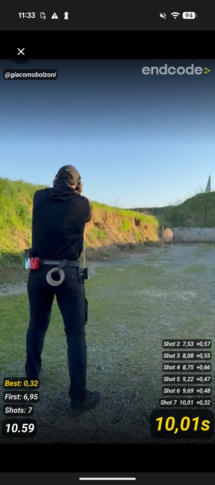 Blast Buddy Android app showing live shot timer overlay on a video of IPSC champion Giacomo Bolzoni at the range — splits, total time, and best split visible